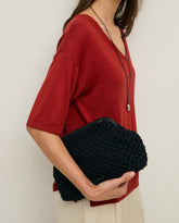 Pochette intrecciata con manico in pelle