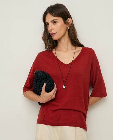 Pochette intrecciata con manico in pelle